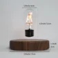 A floating light bulb above a wooden base with measurements: 2.4 inches (6 cm) in width, 4.3 inches (11 cm) in height for the bulb, and 5.9 inches (15 cm) in width, 1.2 inches (3 cm) in height for the base.