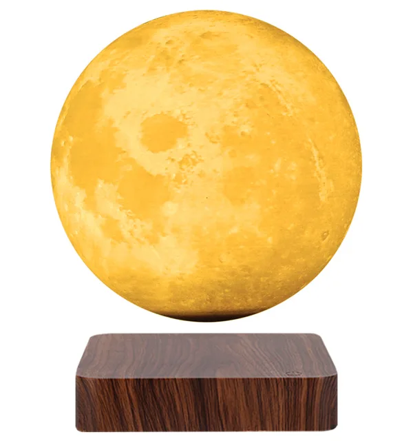 Levitating Moon Lamp with Dark Base A yellow spherical object resembling the moon hovers above a dark wooden base.