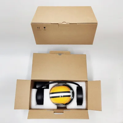 32 type Creative Hover Helmets Magnetic Levitating Helmet with Electromagnetic Stand Suspension Decoration Collectible for Sport 5 Brown cardboard box opened to reveal black and yellow noise-cancelling headphones inside, next to a closed identical box.