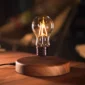 A levitating light bulb hovers above a wooden base, emitting a warm glow.