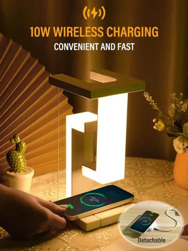 LED Night Lamp Creativity Physics Balance Suspension Table Desk Lamp Wireless Charger Decoration Home Bedroom Room Decor Light 4 Lamp with a geometric design on a table, featuring 10W wireless charging. A phone is charging wirelessly. Decorative elements include a small cactus and flowers.