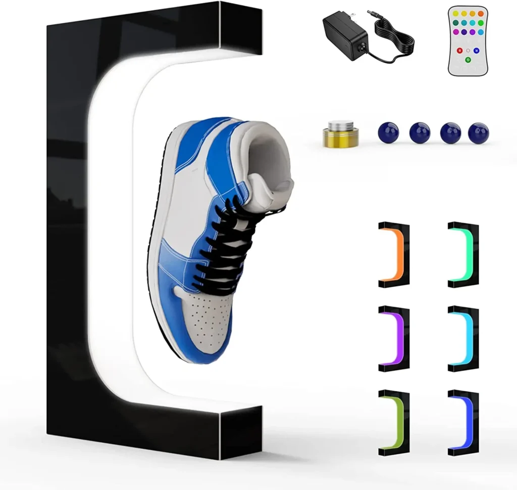Shoe levitating between two magnetic stands, with remote control, power adapter, fragrance capsule, and blue balls displayed. Various color settings shown below the shoe.