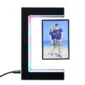 A digital photo frame with a C-shaped stand displaying a couple posing on a beach. The frame features LED lighting and is plugged in with a cord.