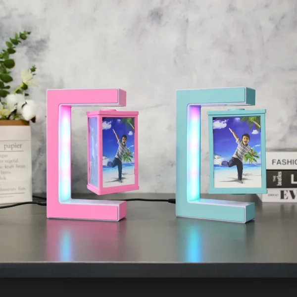 Magnetic Levitating Picture Photo Frame Creative Night Light With Led Lights Display Birthday Christmas Gift 5 Two rectangular LED photo frames, one pink and one blue, display a picture of a person with a palm tree background. The frames stand on a reflective surface against a gray wall.