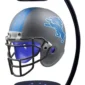 A gray and blue football helmet with a lion logo, displayed on a black stand with a magnetic levitation design.