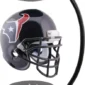 A black football helmet floats between magnetic bases, featuring a red, white, and blue abstract logo with a star.