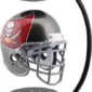 Floating football helmet with gray facemask and a red and black team logo is suspended between two black magnets on a curved stand.
