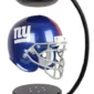 A floating football helmet with a blue and red design, supported by a black, curved stand.