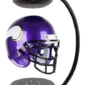 A purple football helmet with a white and gold horn design is suspended between a top and bottom base using magnetic levitation.