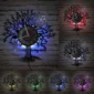 Vinyl record wall clock with a tree design and musical notes, featuring colored LED backlighting in various hues: blue, red, purple, yellow, and green.