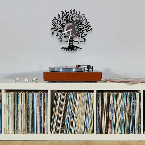 Music is My Soul Modern Design Music Classic Black Hanging Vinyl Record Clocks Wall Watch Home Decor Musician Rock n Roll Gift 4 A record player on a white shelf filled with vinyl records. Above, there is a decorative clock with a tree design and the words "Music feeds my soul.