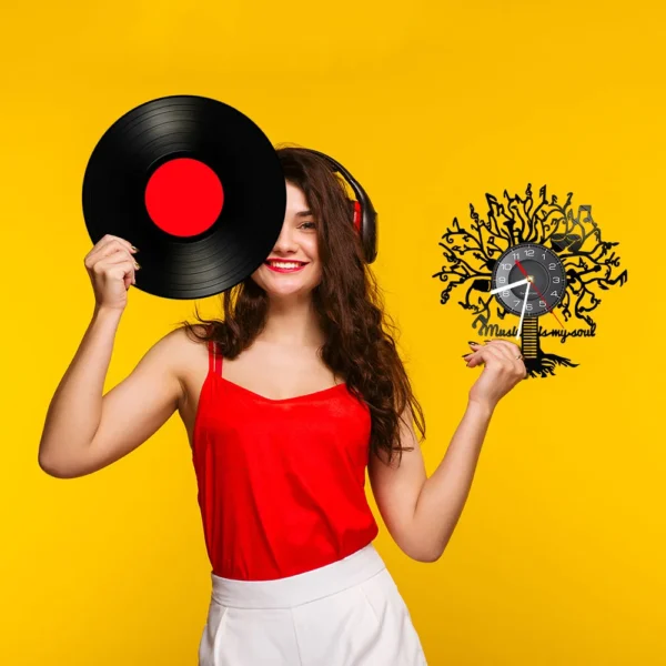 Music is My Soul Modern Design Music Classic Black Hanging Vinyl Record Clocks Wall Watch Home Decor Musician Rock n Roll Gift 6 Woman in a red top holds a vinyl record and a clock with a decorative design against a yellow background.