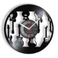 Wall clock decorated with black silhouettes of various guitars around the edge, featuring a round central clock face with white numerals and red second hand.