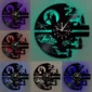 Wall clocks made from vinyl records depict a space-themed design with various colorful LED backlights.