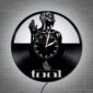 The Skeletal Brain Wall Clock is crafted from a vinyl record and showcases a design featuring a human figure with a brain, spine, and flame symbol, along with the word "Tool" at the bottom.