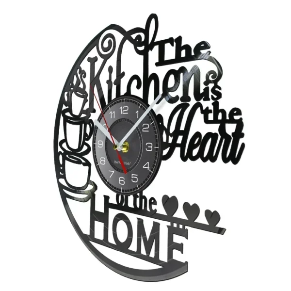 The Kitchen The Heart of The Home Inspired Vinyl Record Clock Modern Design Vinyl Wall Watch Kitchen Decor Noiseless Timepieces 3 Round clock with black frame featuring the phrase "The Kitchen is the Heart of the Home" in a decorative font, with coffee cup designs and heart accents.
