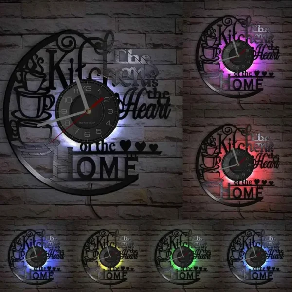 The Kitchen The Heart of The Home Inspired Vinyl Record Clock Modern Design Vinyl Wall Watch Kitchen Decor Noiseless Timepieces 5 Wall clock with cups and the phrase "The Kitchen is the Heart of the Home," illuminated in various colors including purple, red, green, yellow, and blue.