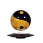 A black and gold sphere with a yin-yang design hovers above a black, rectangular base.