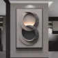 Wall art with overlapping circular shapes in grey tones, mounted on a beige wall in a modern interior.