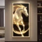 An illuminated painting of a white horse, featuring golden accents, displayed on a wall in a modern living room.