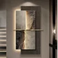 A textured wall art piece with layered panels, divided by a horizontal line, is lit by ambient lighting.