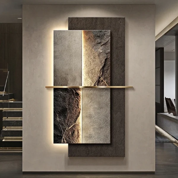 Abstract wall art with textured panels, featuring earth tones and a vertical golden bar dividing the sections. The artwork is illuminated from behind, mounted on a plain wall.